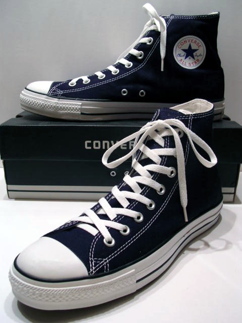 A_classic_Black_pair_of_Converse_All_Stars_resting_on_the_Black_&_White_Ed._Shoebox_(1998-2002)