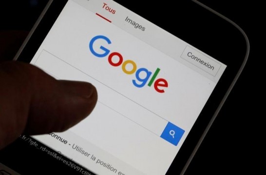 A man holds his smartphone which displays the Google home page, in this picture illustration taken in Bordeaux, Southwestern France