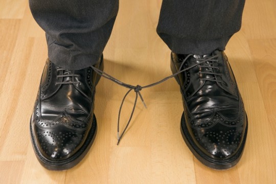 Business man with knotted laces