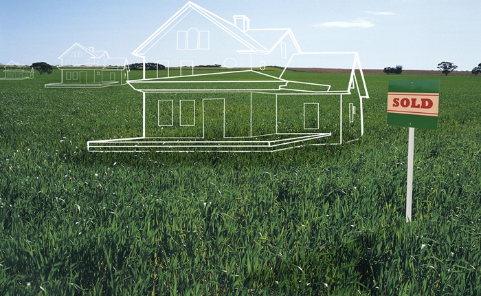 House plans on lawn by 'sold' sign (digital composite)