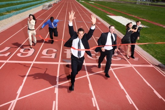 Business people crossing finish line