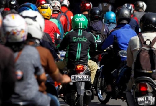 A Grab bike rider is seen during rush hour traffic in Jakarta