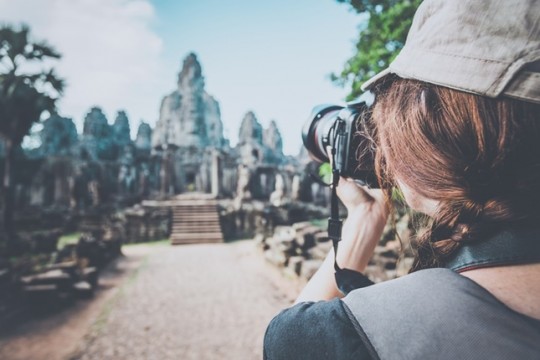 Woman Photographer Taking Picture at Angkor Wat, Cambodia
