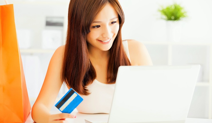 Young woman  shopping online with credit card and laptop